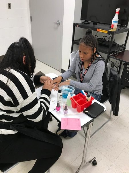 Avion Bryant receiving a manicure.  Her twin sister, Autumn was also treated to a manicure.